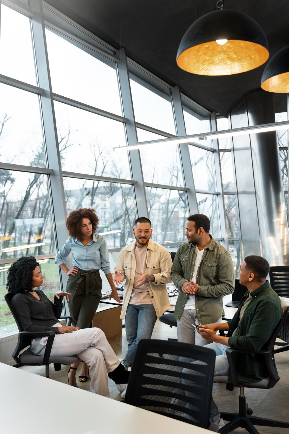 Business team discussing web design strategy in modern office with computers and creative collaboration