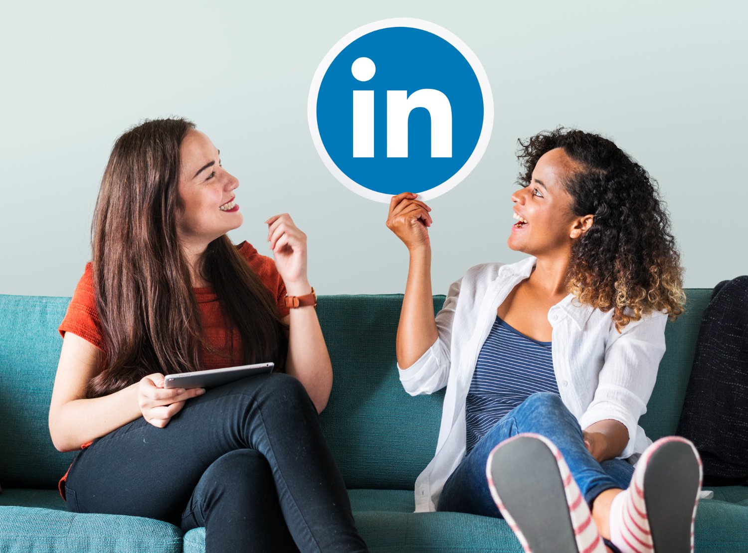 Women holding LinkedIn logo representing LinkedIn marketing services in Lahore, professional networking, B2B marketing, lead generation, and digital marketing strategy