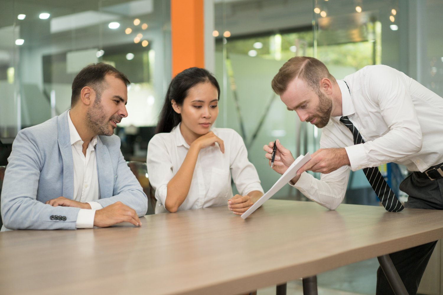 Business team collaborating in office while manager presents new idea to colleagues