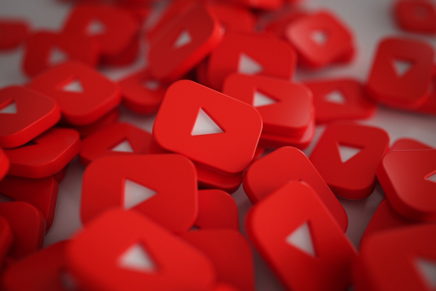 Pile of 3D YouTube play button logos representing YouTube marketing services in Lahore, video marketing, content creation, channel promotion, and digital advertising strategy